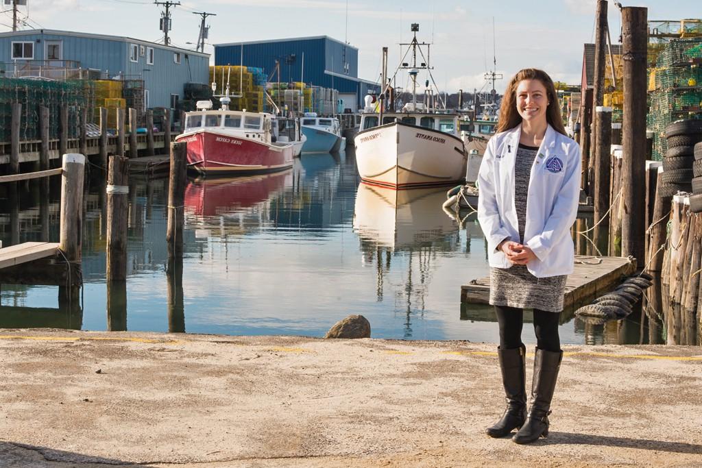 A dental student stands at Widgery Wharf in downtown Portland, Maine