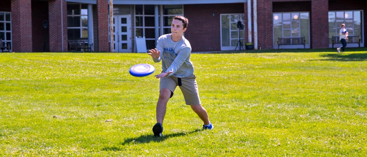 A student catching a frisbee
